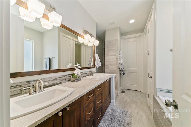 5726 N Morpheus Way, Meridian, ID 83642 - bathroom featuring double vanity, tile patterned flooring, backsplash, and recessed lighting