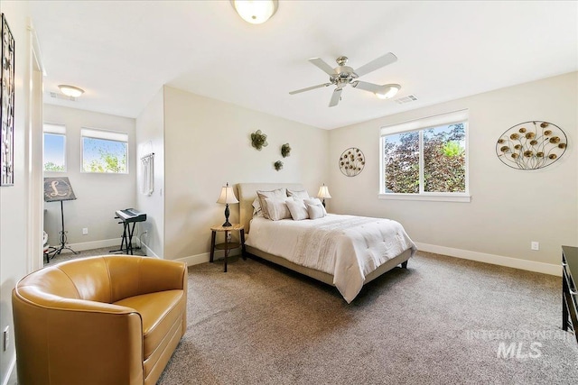 5726 N Morpheus Way, Meridian, ID 83642 - carpeted bedroom featuring multiple windows, baseboards, and a ceiling fan