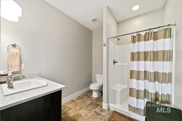 5726 N Morpheus Way, Meridian, ID 83642 - full bath featuring baseboards, toilet, a shower with shower curtain, vanity, and stone finish floors