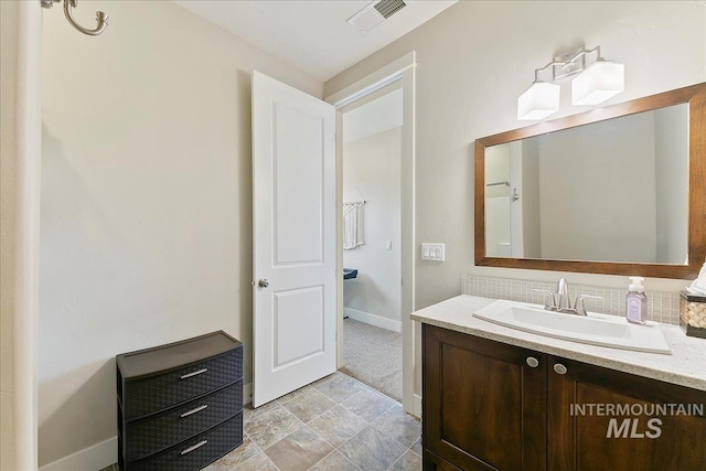 5726 N Morpheus Way, Meridian, ID 83642 - bathroom featuring vanity, baseboards, and backsplash