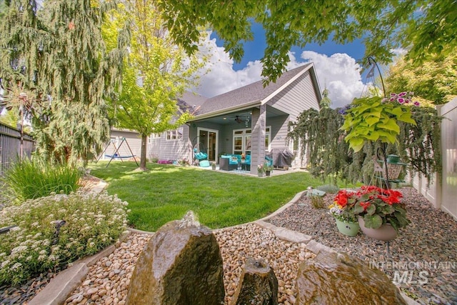 5726 N Morpheus Way, Meridian, ID 83642 - back of property with ceiling fan, outdoor lounge area, and a patio area