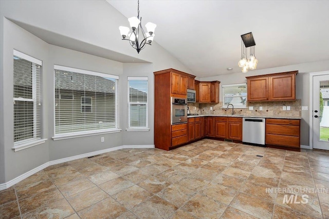 kitchen featuring backsplash, appliances with stainless steel finishes, vaulted ceiling, and decorative light fixtures