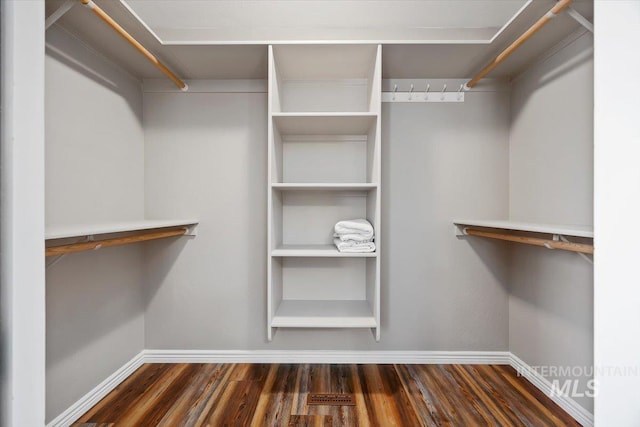 walk in closet featuring dark hardwood / wood-style floors