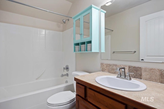 full bathroom featuring vanity, toilet, decorative backsplash, and shower / washtub combination