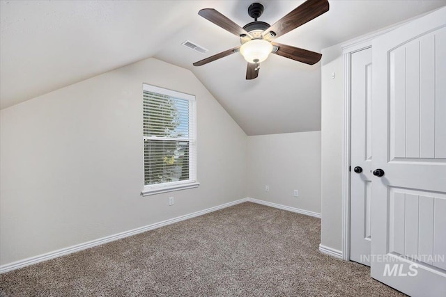 additional living space with carpet floors, ceiling fan, and vaulted ceiling