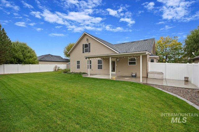 rear view of property featuring a yard and a patio