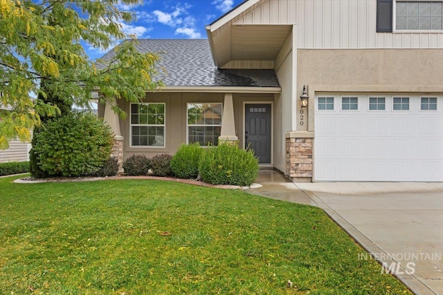 property entrance featuring a yard and a garage