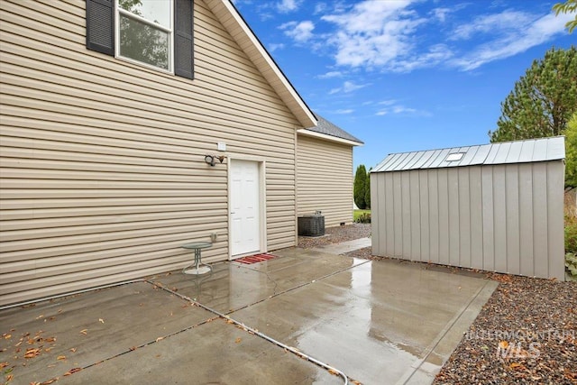 view of patio / terrace featuring a storage shed and central AC unit