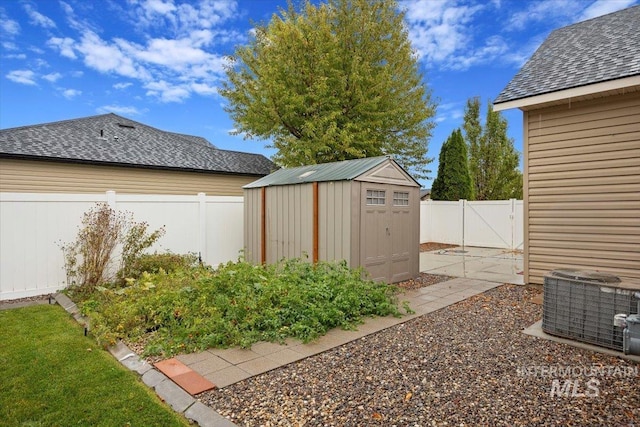 view of yard featuring central air condition unit and a storage shed