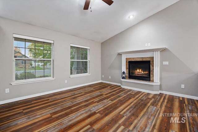 unfurnished living room featuring dark wood-type flooring, ceiling fan, and lofted ceiling