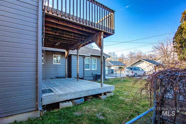 wooden deck featuring a yard