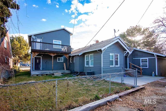 rear view of house featuring a balcony and a patio area