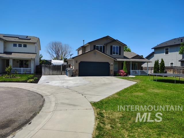 2150 W Shy Crk, Nampa, ID 83686 - view of front of property featuring concrete driveway, a porch, an attached garage, and a trampoline