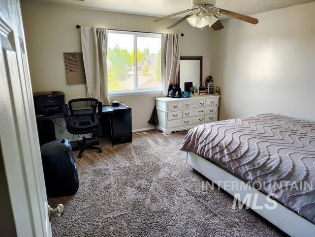 2150 W Shy Crk, Nampa, ID 83686 - bedroom with carpet, a desk, and ceiling fan