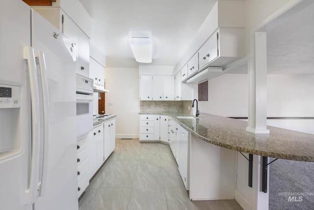 2144 Crestwood Dr, Twin Falls, ID 83301 - kitchen with white appliances, a sink, a peninsula, stone counters, and white cabinets