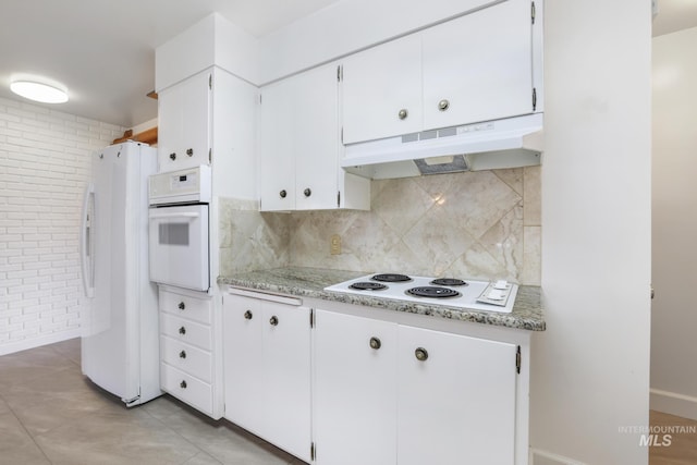 2144 Crestwood Dr, Twin Falls, ID 83301 - kitchen with white appliances, under cabinet range hood, white cabinetry, tasteful backsplash, and light tile patterned flooring