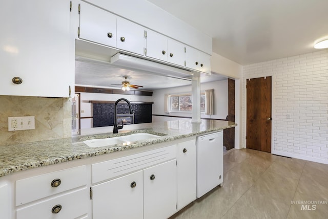 2144 Crestwood Dr, Twin Falls, ID 83301 - kitchen featuring dishwasher, a sink, brick wall, white cabinetry, and light stone counters
