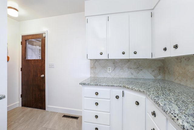 2144 Crestwood Dr, Twin Falls, ID 83301 - kitchen featuring tasteful backsplash, baseboards, light stone countertops, and white cabinetry