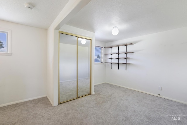 2144 Crestwood Dr, Twin Falls, ID 83301 - unfurnished bedroom featuring carpet, a closet, baseboards, and a textured ceiling