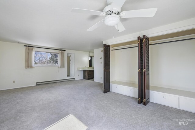 2144 Crestwood Dr, Twin Falls, ID 83301 - unfurnished living room featuring baseboard heating, carpet, and ceiling fan