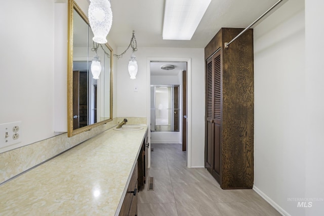 2144 Crestwood Dr, Twin Falls, ID 83301 - full bath featuring vanity, baseboards, tile patterned flooring, and a shower