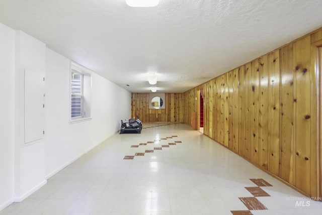 2144 Crestwood Dr, Twin Falls, ID 83301 - below grade area with wood walls, plenty of natural light, baseboards, and a textured ceiling