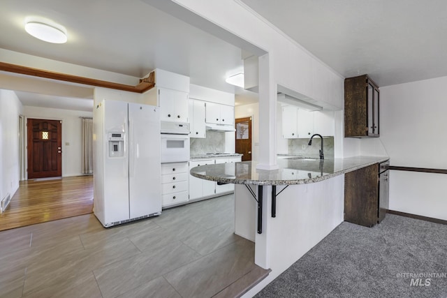 2144 Crestwood Dr, Twin Falls, ID 83301 - kitchen with white appliances, white cabinets, a peninsula, tasteful backsplash, and a sink