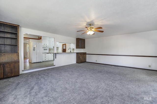2144 Crestwood Dr, Twin Falls, ID 83301 - unfurnished living room with carpet flooring, ceiling fan, a sink, and baseboards