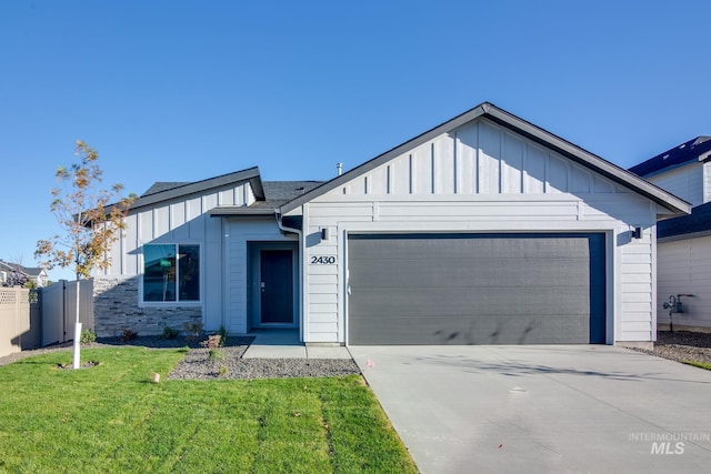 5814 W Mikonos St, Meridian, ID 83646 - view of front of home with concrete driveway, board and batten siding, a front yard, a garage, and fence