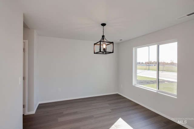 5814 W Mikonos St, Meridian, ID 83646 - unfurnished dining area with visible vents, baseboards, an inviting chandelier, and dark wood finished floors