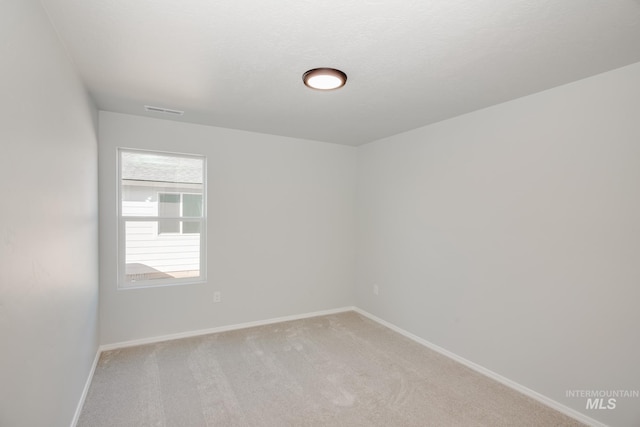 5814 W Mikonos St, Meridian, ID 83646 - spare room with light carpet, visible vents, baseboards, and a textured ceiling