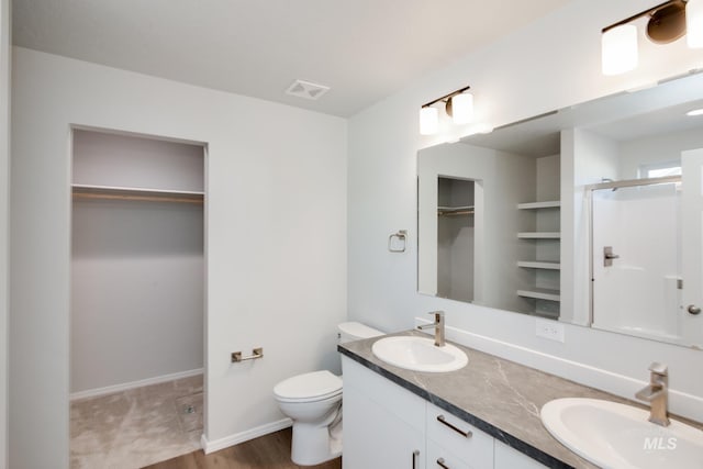 5814 W Mikonos St, Meridian, ID 83646 - bathroom with a walk in closet, visible vents, a sink, and a stall shower