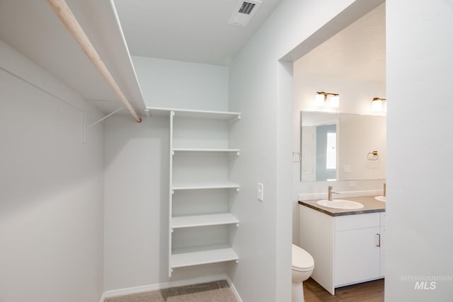 5814 W Mikonos St, Meridian, ID 83646 - half bathroom featuring visible vents, toilet, vanity, and baseboards