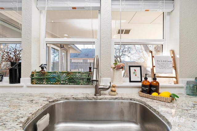 interior details with sink and light stone counters