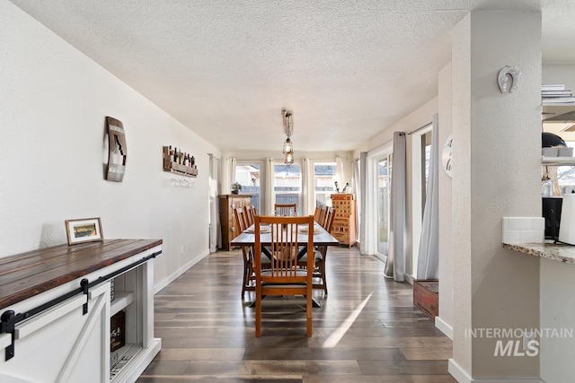 dining room featuring a textured ceiling and dark hardwood / wood-style flooring