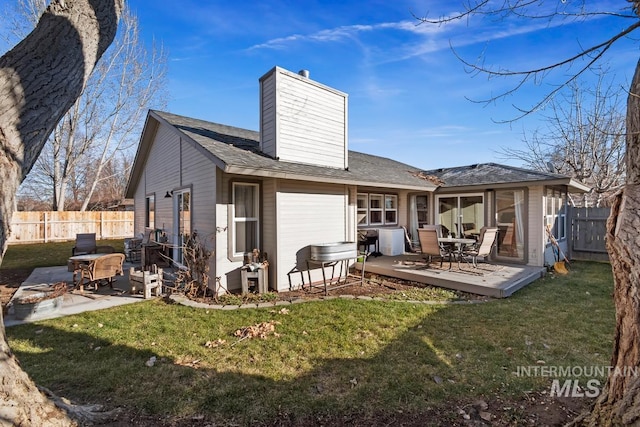 rear view of house with a lawn and a patio