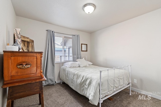 carpeted bedroom with a textured ceiling