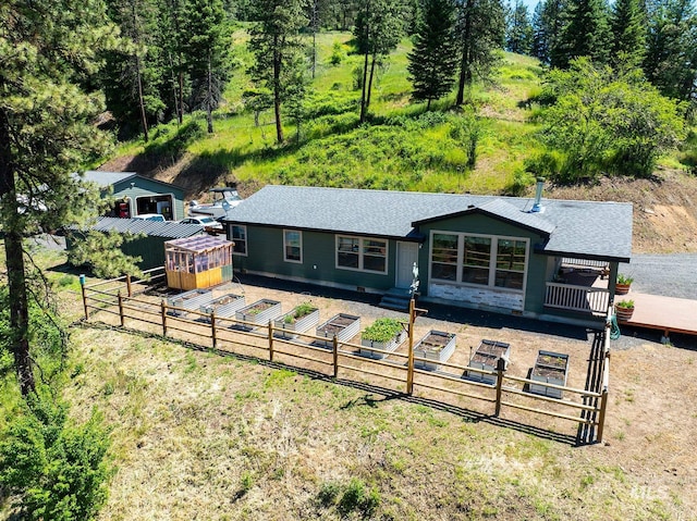 110 Memory Ln, Kamiah, ID 83536 - rear view of property featuring a deck, roof with shingles, and an outdoor structure