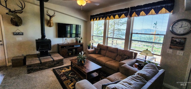 110 Memory Ln, Kamiah, ID 83536 - living room featuring a wood stove, ceiling fan, and baseboards
