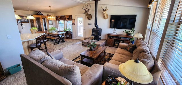 110 Memory Ln, Kamiah, ID 83536 - carpeted living room with a wood stove, lofted ceiling, a chandelier, and baseboards