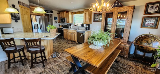 110 Memory Ln, Kamiah, ID 83536 - kitchen with appliances with stainless steel finishes, a chandelier, light countertops, and dark wood-style flooring