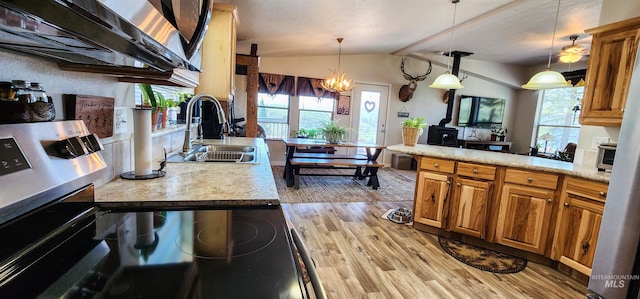 110 Memory Ln, Kamiah, ID 83536 - kitchen featuring a sink, vaulted ceiling, wood finished floors, plenty of natural light, and light countertops