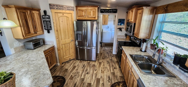 110 Memory Ln, Kamiah, ID 83536 - kitchen with appliances with stainless steel finishes, a sink, wood finished floors, light countertops, and pendant lighting