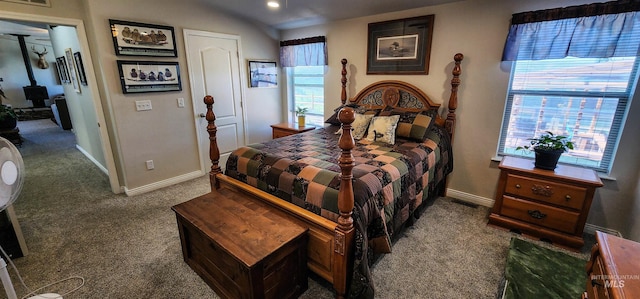 110 Memory Ln, Kamiah, ID 83536 - bedroom with carpet floors, multiple windows, baseboards, a wood stove, and recessed lighting