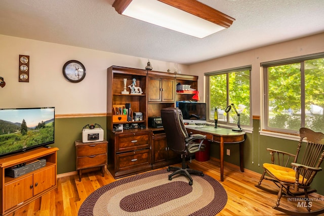 office featuring a textured ceiling and light hardwood / wood-style floors