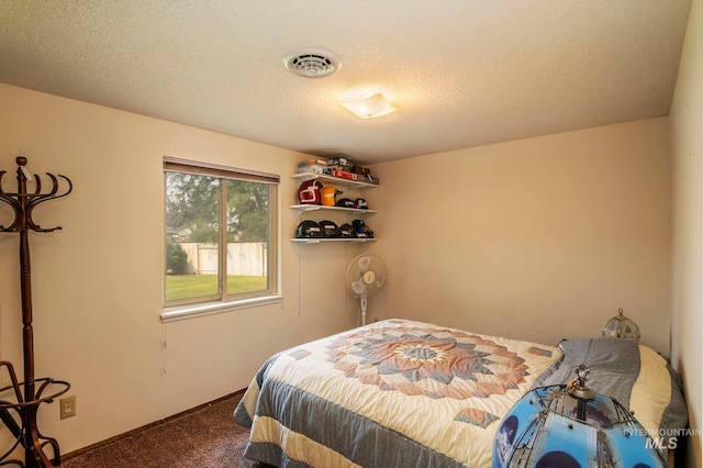 carpeted bedroom with a textured ceiling