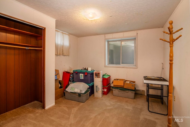 carpeted bedroom with a closet and a textured ceiling