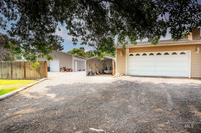 view of front of property with a garage and a carport