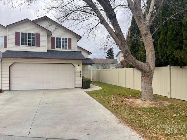 exterior space with a yard and a garage