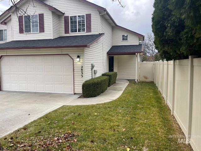 view of front of property featuring a front lawn and a garage